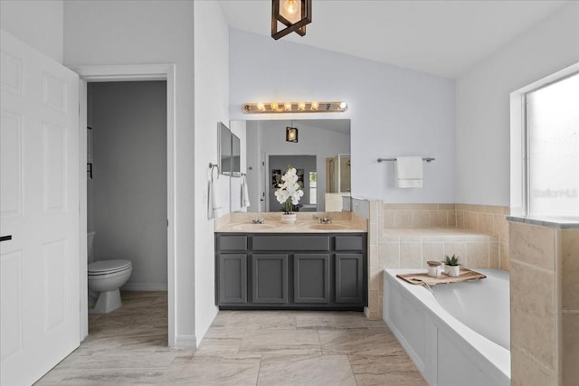 119 Argyle Gate Loop Rd, Dundee, FL 33838 - bathroom with vaulted ceiling, double vanity, a bath, and toilet
