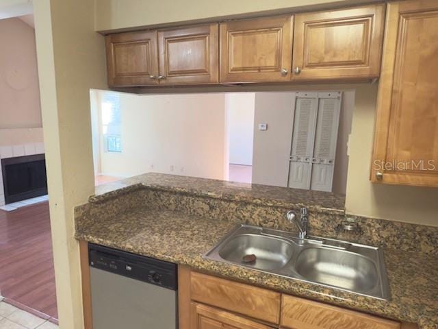 208 Afton Sq Unit 307, Altamonte Springs, FL 32714 - kitchen with dishwasher, a sink, and brown cabinets