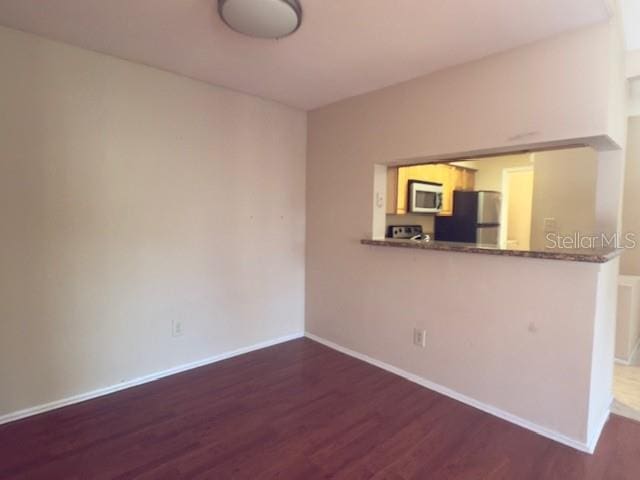 208 Afton Sq Unit 307, Altamonte Springs, FL 32714 - unfurnished room featuring wood finished floors and baseboards