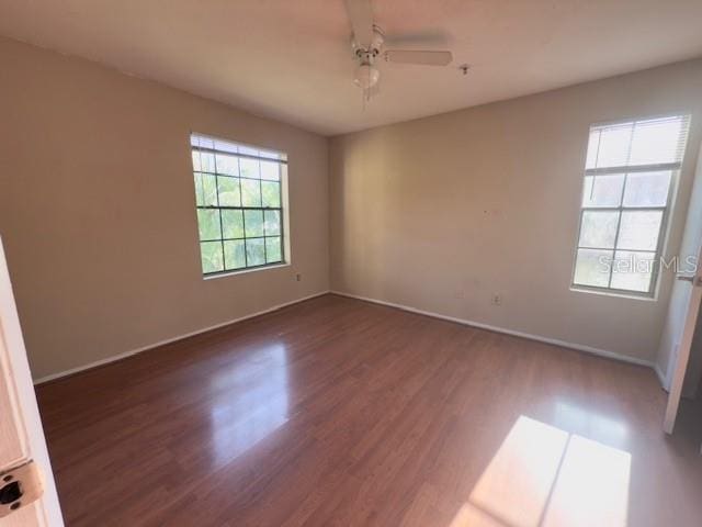 208 Afton Sq Unit 307, Altamonte Springs, FL 32714 - spare room with dark wood finished floors, baseboards, and ceiling fan