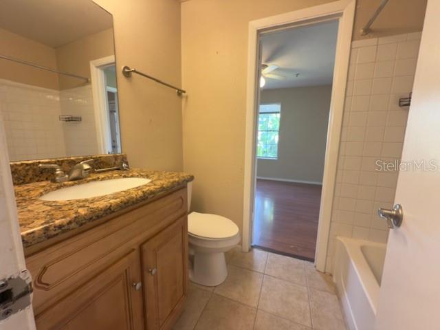 208 Afton Sq Unit 307, Altamonte Springs, FL 32714 - bathroom with tile patterned flooring, toilet, vanity, a ceiling fan, and bathing tub / shower combination