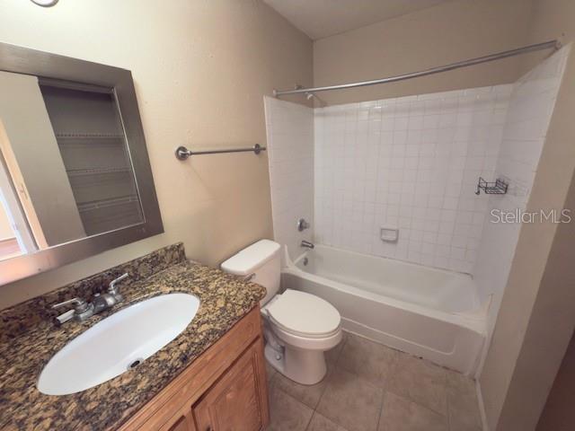 208 Afton Sq Unit 307, Altamonte Springs, FL 32714 - bathroom featuring toilet, vanity, tile patterned flooring, and shower / washtub combination