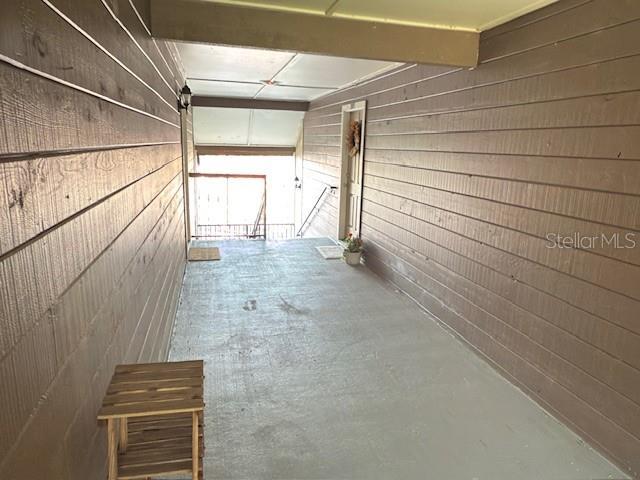 208 Afton Sq Unit 307, Altamonte Springs, FL 32714 - hallway featuring concrete floors and wooden walls