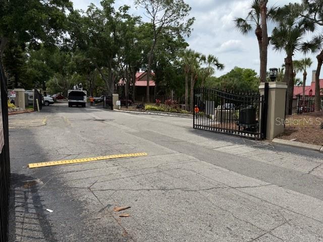 208 Afton Sq Unit 307, Altamonte Springs, FL 32714 - view of asphalt street with curbs, a gate, and a gated entry
