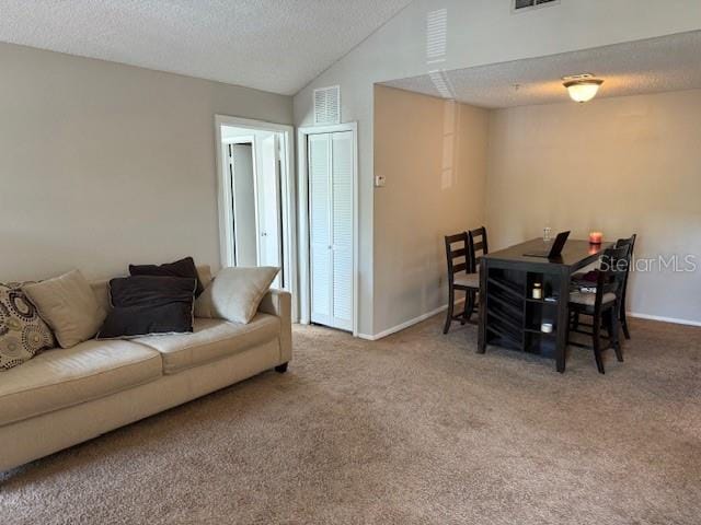 224 Afton Sq Unit 301, Altamonte Springs, FL 32714 - carpeted living area featuring vaulted ceiling, a textured ceiling, and baseboards