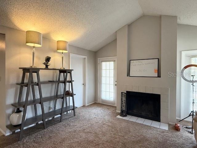224 Afton Sq Unit 301, Altamonte Springs, FL 32714 - carpeted living area with vaulted ceiling, healthy amount of natural light, a textured ceiling, and a tile fireplace