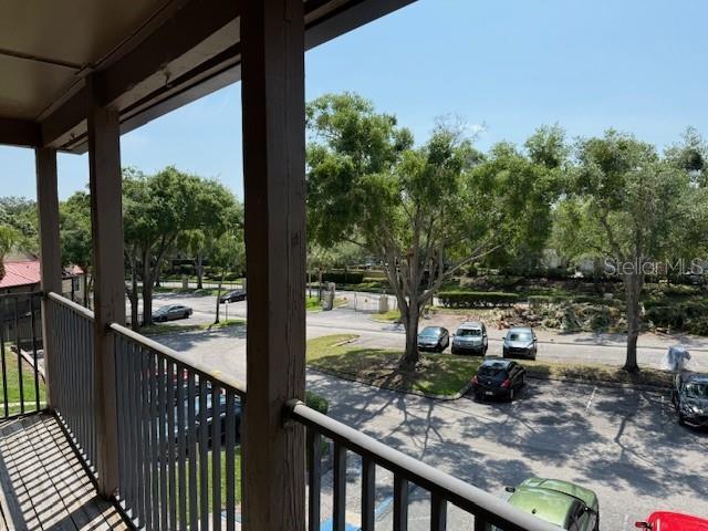 224 Afton Sq Unit 301, Altamonte Springs, FL 32714 - balcony with a porch and view of wooded area