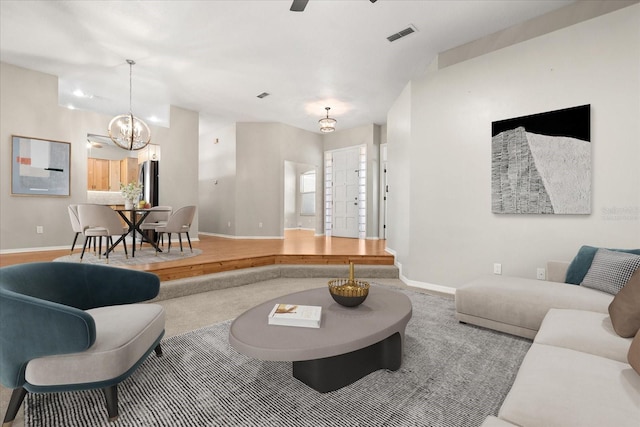 14841 Faversham Cir, Orlando, FL 32826 - living room featuring baseboards and a chandelier