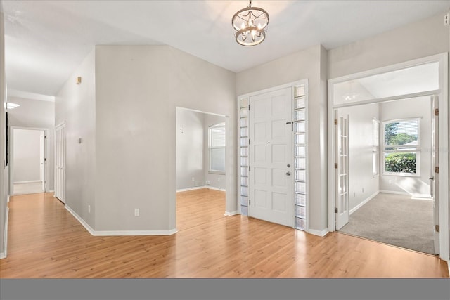 14841 Faversham Cir, Orlando, FL 32826 - entrance foyer featuring wood finished floors, a chandelier, and baseboards