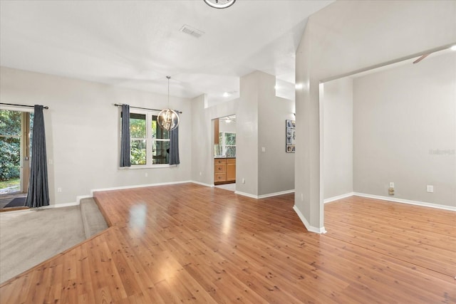 14841 Faversham Cir, Orlando, FL 32826 - unfurnished living room featuring healthy amount of natural light, baseboards, and wood finished floors
