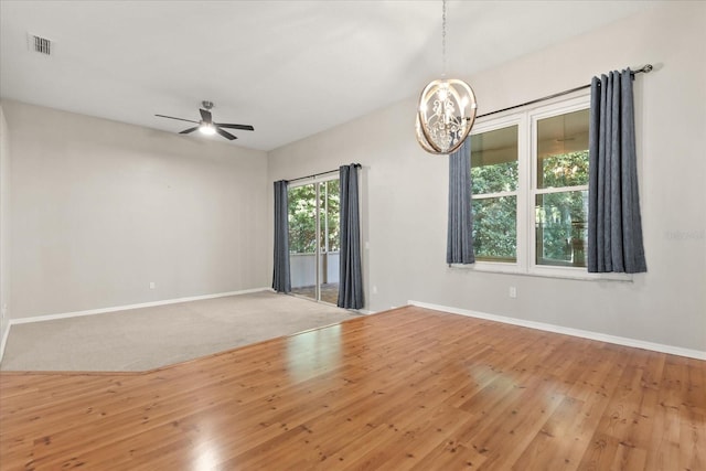 14841 Faversham Cir, Orlando, FL 32826 - spare room with a chandelier, baseboards, ceiling fan, and wood finished floors