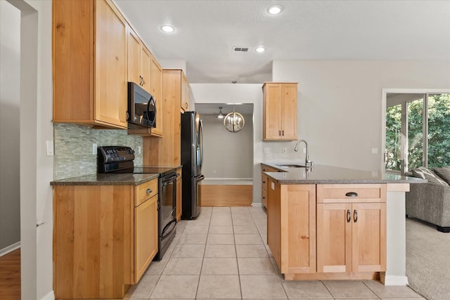 14841 Faversham Cir, Orlando, FL 32826 - kitchen featuring black / electric stove, a sink, freestanding refrigerator, tasteful backsplash, and light brown cabinets
