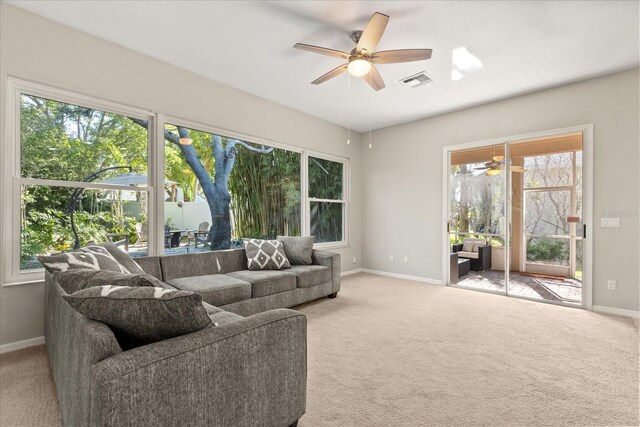 14841 Faversham Cir, Orlando, FL 32826 - carpeted living room featuring a ceiling fan, baseboards, and plenty of natural light