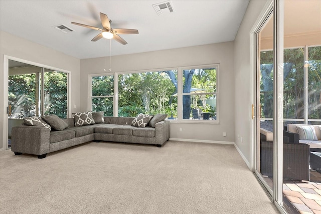 14841 Faversham Cir, Orlando, FL 32826 - living room with ceiling fan, light carpet, and baseboards