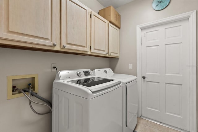 14841 Faversham Cir, Orlando, FL 32826 - laundry area with cabinet space, washing machine and dryer, and light tile patterned floors