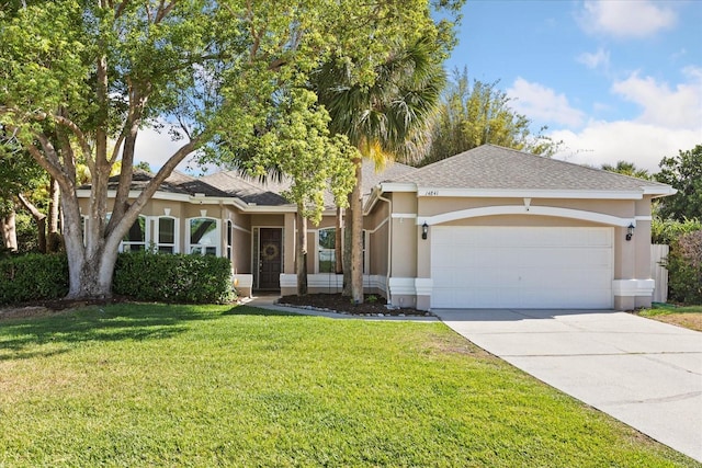 14841 Faversham Cir, Orlando, FL 32826 - view of front of home with a garage, concrete driveway, stucco siding, and a front lawn