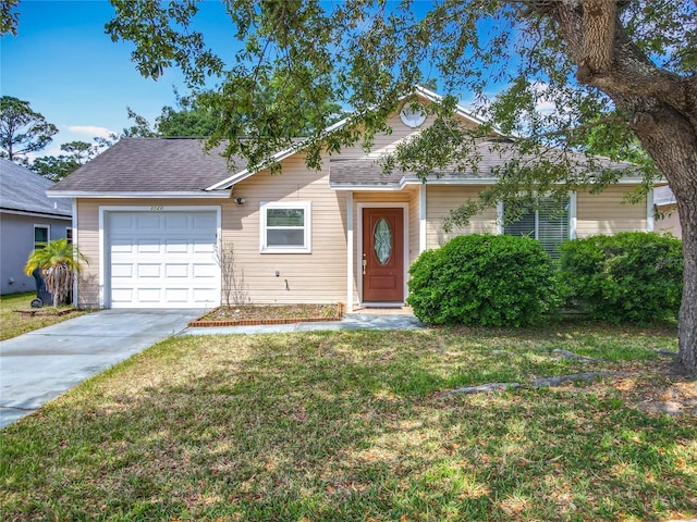 view of front of house featuring roof with shingles, a front yard, concrete driveway, and an attached garage