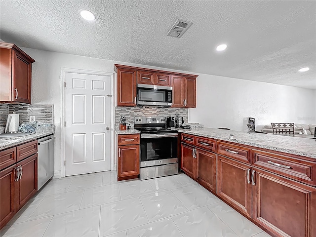 kitchen with a textured ceiling, tasteful backsplash, appliances with stainless steel finishes, visible vents, and dark brown cabinets
