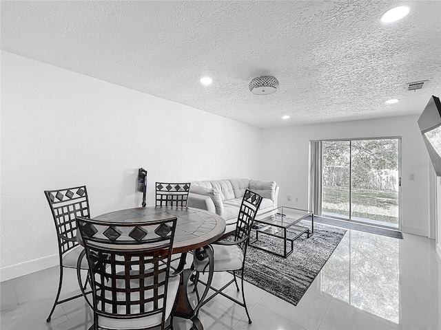 dining room with recessed lighting, a textured ceiling, visible vents, and baseboards