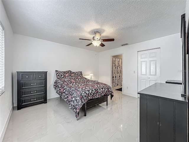 bedroom with marble finish floor, visible vents, a ceiling fan, baseboards, and a textured ceiling