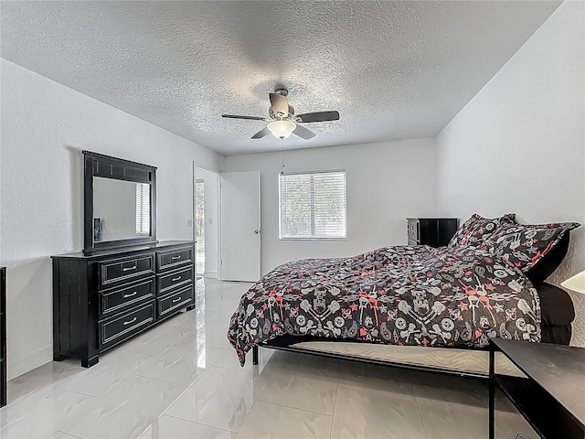 bedroom with a textured ceiling and ceiling fan