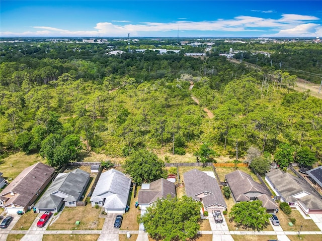 birds eye view of property featuring a residential view and a view of trees