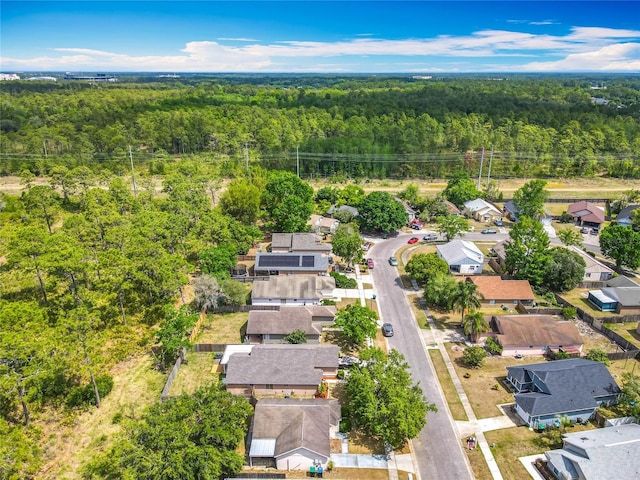 drone / aerial view featuring a residential view and a forest view