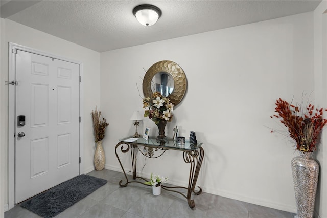 1220 Tahitian Sunrise Dr, Plant City, FL 33565 - tiled entrance foyer featuring a textured ceiling and baseboards