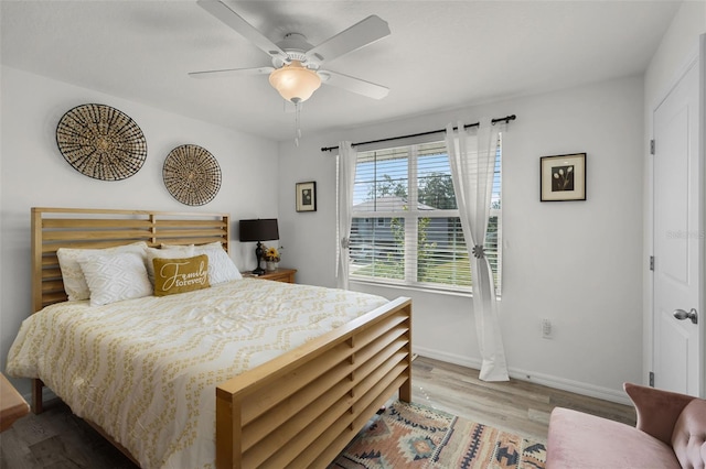 1220 Tahitian Sunrise Dr, Plant City, FL 33565 - bedroom featuring wood finished floors, a ceiling fan, and baseboards