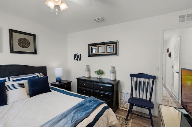 1220 Tahitian Sunrise Dr, Plant City, FL 33565 - bedroom with wood finished floors, visible vents, a ceiling fan, and baseboards