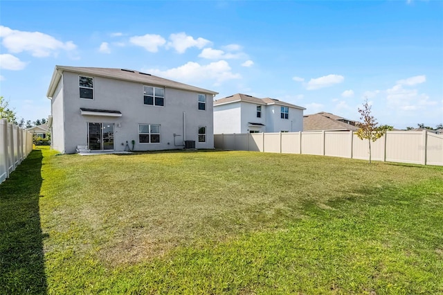 1220 Tahitian Sunrise Dr, Plant City, FL 33565 - back of house featuring stucco siding, central AC unit, a lawn, and a fenced backyard