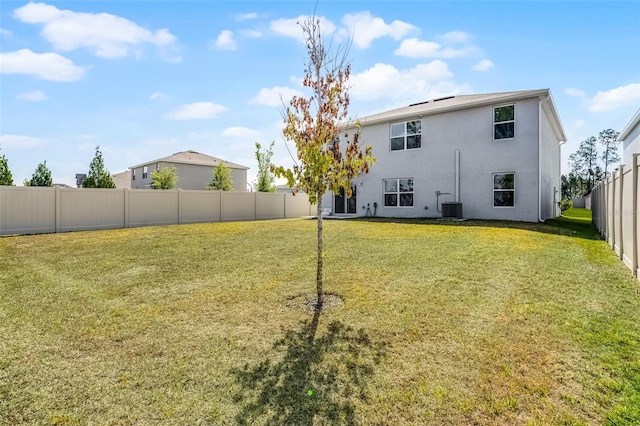 1220 Tahitian Sunrise Dr, Plant City, FL 33565 - rear view of house featuring cooling unit, a yard, stucco siding, and a fenced backyard