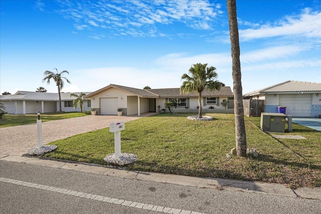 4043 Topsail Trl, New Port Richey, FL 34652 - ranch-style home featuring an attached garage, decorative driveway, stucco siding, and a front yard