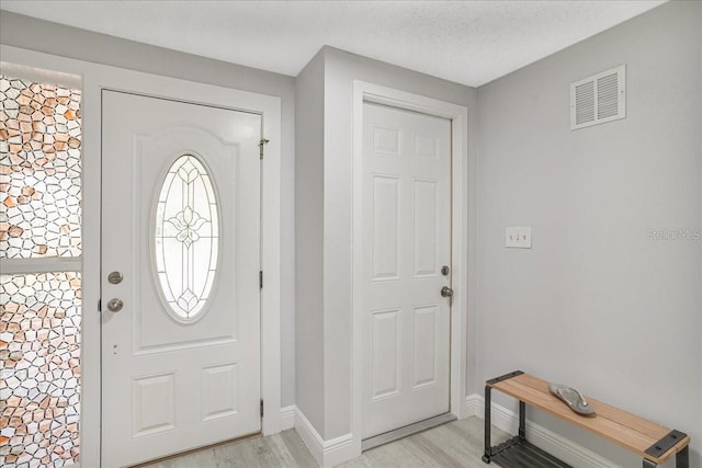 4043 Topsail Trl, New Port Richey, FL 34652 - entryway with visible vents, light wood finished floors, and baseboards
