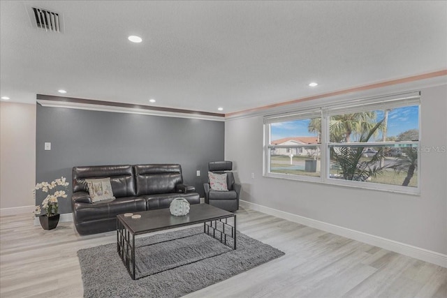4043 Topsail Trl, New Port Richey, FL 34652 - living room with visible vents, baseboards, light wood-style floors, ornamental molding, and recessed lighting