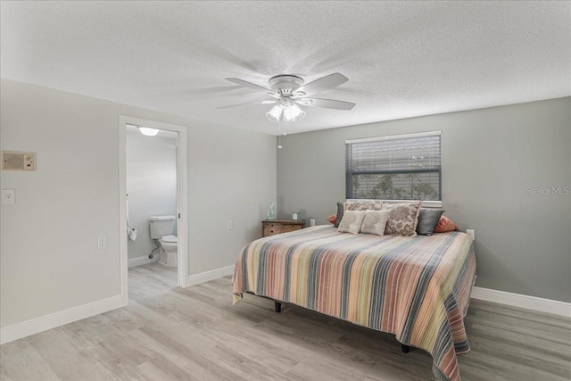 4043 Topsail Trl, New Port Richey, FL 34652 - bedroom featuring baseboards, ensuite bathroom, ceiling fan, a textured ceiling, and light wood-style flooring