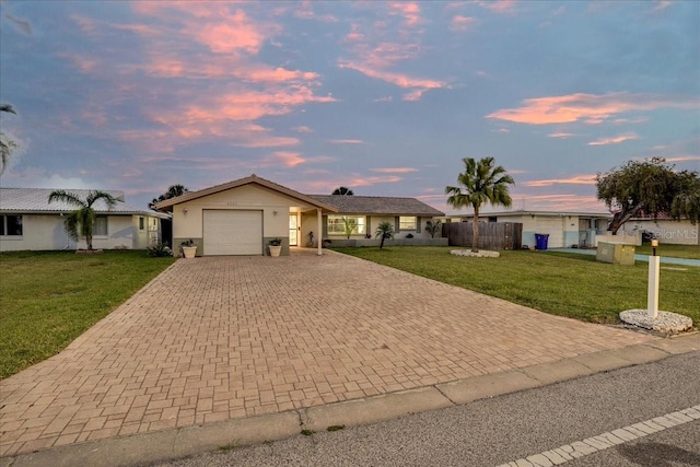 4043 Topsail Trl, New Port Richey, FL 34652 - ranch-style home featuring an attached garage, fence, driveway, and a front yard
