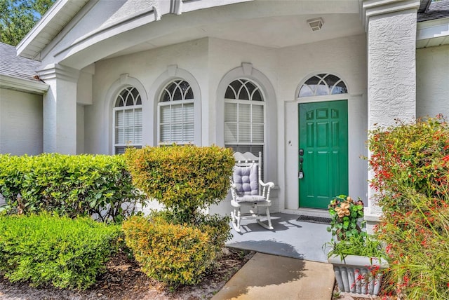 doorway to property with stucco siding