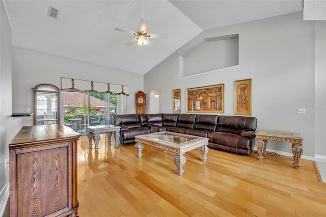 living room with high vaulted ceiling, light wood-type flooring, a ceiling fan, visible vents, and baseboards