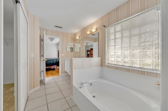 ensuite bathroom with a bath, visible vents, baseboards, wallpapered walls, and ensuite bathroom