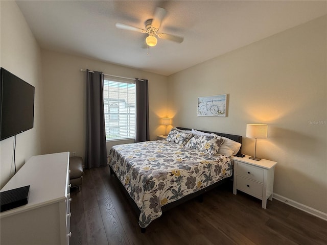 bedroom featuring a ceiling fan, dark wood finished floors, and baseboards