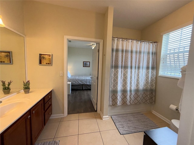 bathroom with tile patterned floors, toilet, vanity, and baseboards