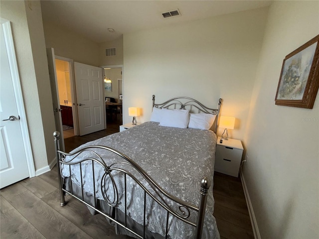 bedroom featuring visible vents, dark wood-style floors, and baseboards