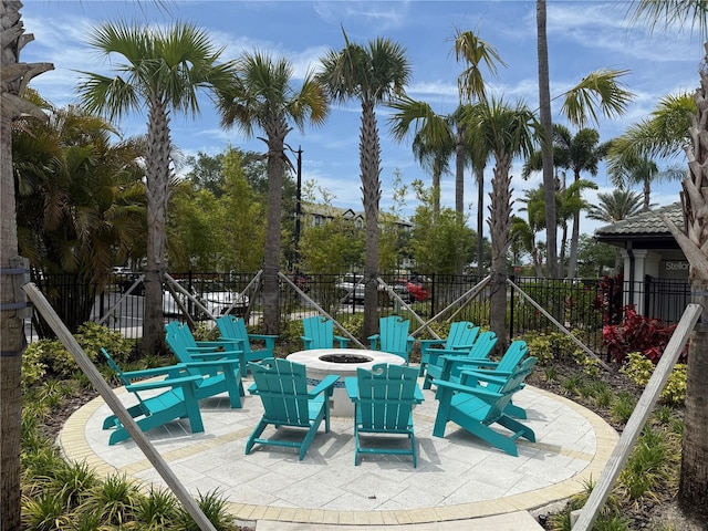 view of patio featuring a fire pit and fence