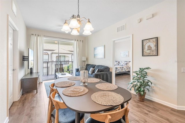 4024 Breakview Dr Unit 40604, Orlando, FL 32819 - dining area with a chandelier and light wood-type flooring