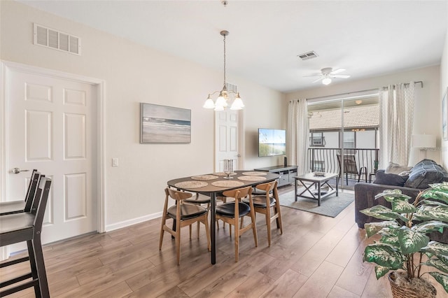 4024 Breakview Dr Unit 40604, Orlando, FL 32819 - dining area with light wood-style flooring, ceiling fan, and a chandelier