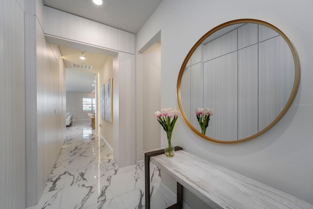 hall with recessed lighting, marble finish floor, visible vents, and baseboards