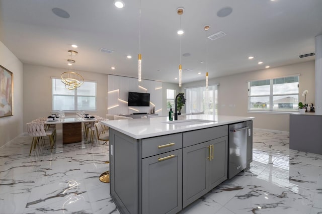 kitchen with gray cabinets, light countertops, dishwasher, a sink, and visible vents