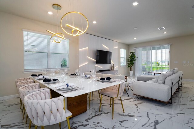 dining space with a notable chandelier, marble finish floor, visible vents, and recessed lighting