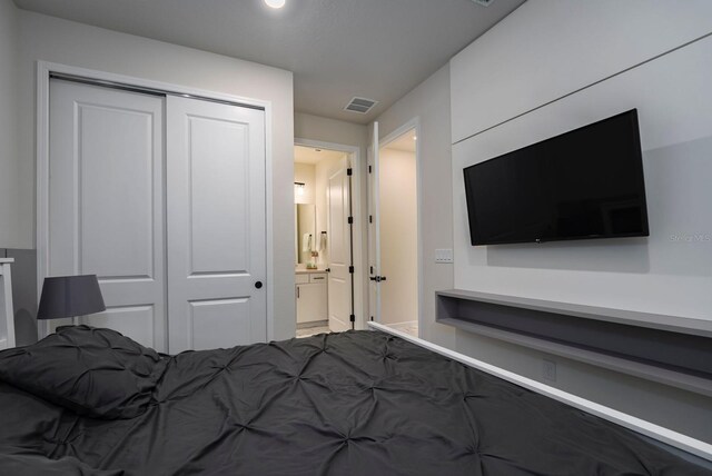 bedroom featuring visible vents and a closet